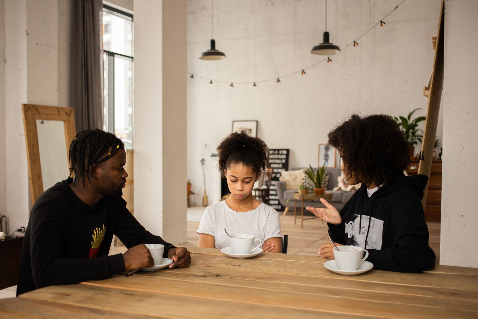 A family in supportive conversation around a kitchen table
